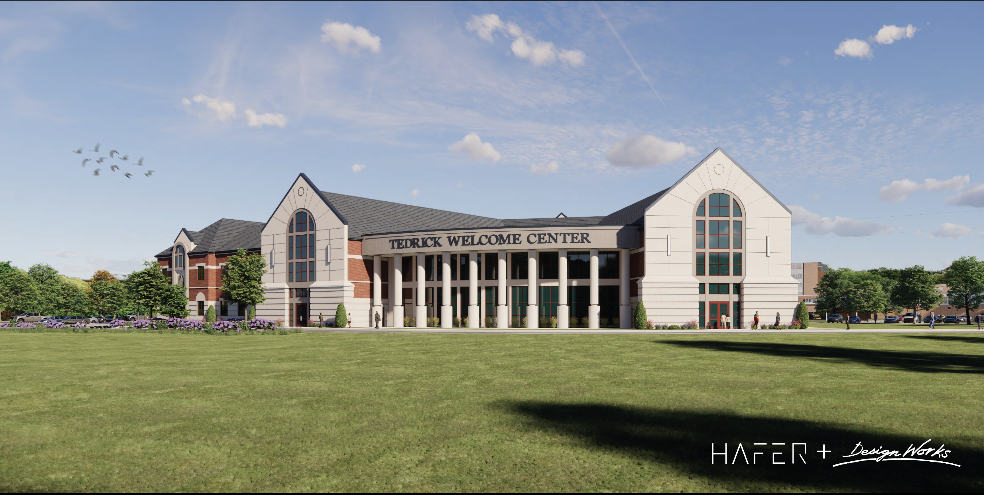The architectural design of the Tedrick Welcome Center showcases large white pillars, arched windows, and red brick accents.
